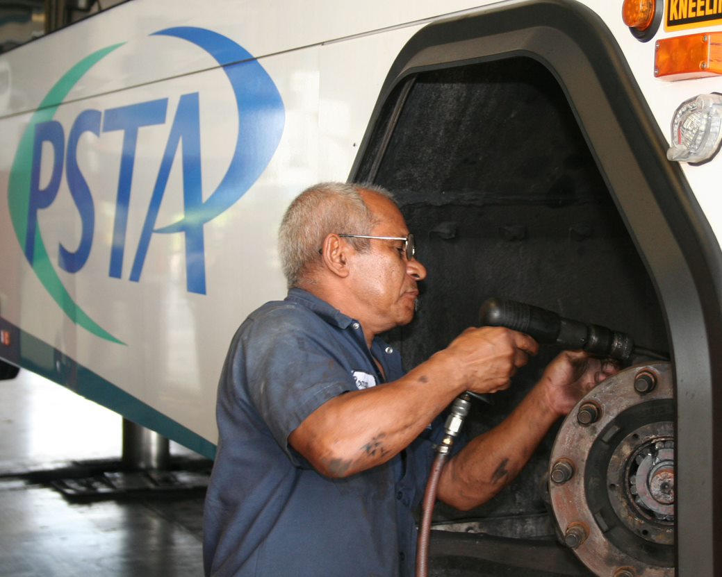 Technician repairing the axle of a PSTA bus