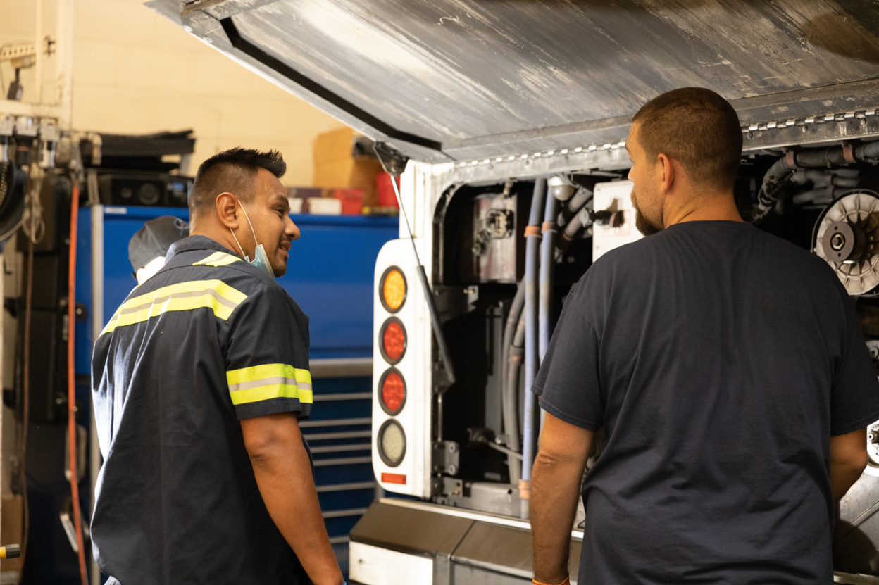 Two technicians working on a PSTA bus