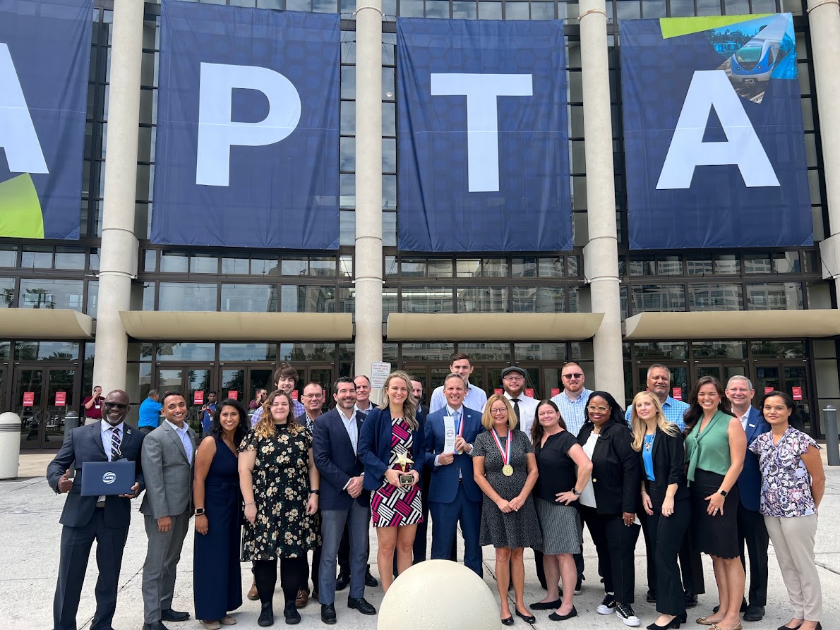 PSTA leaders and employees standing outside the APTA conference with awards