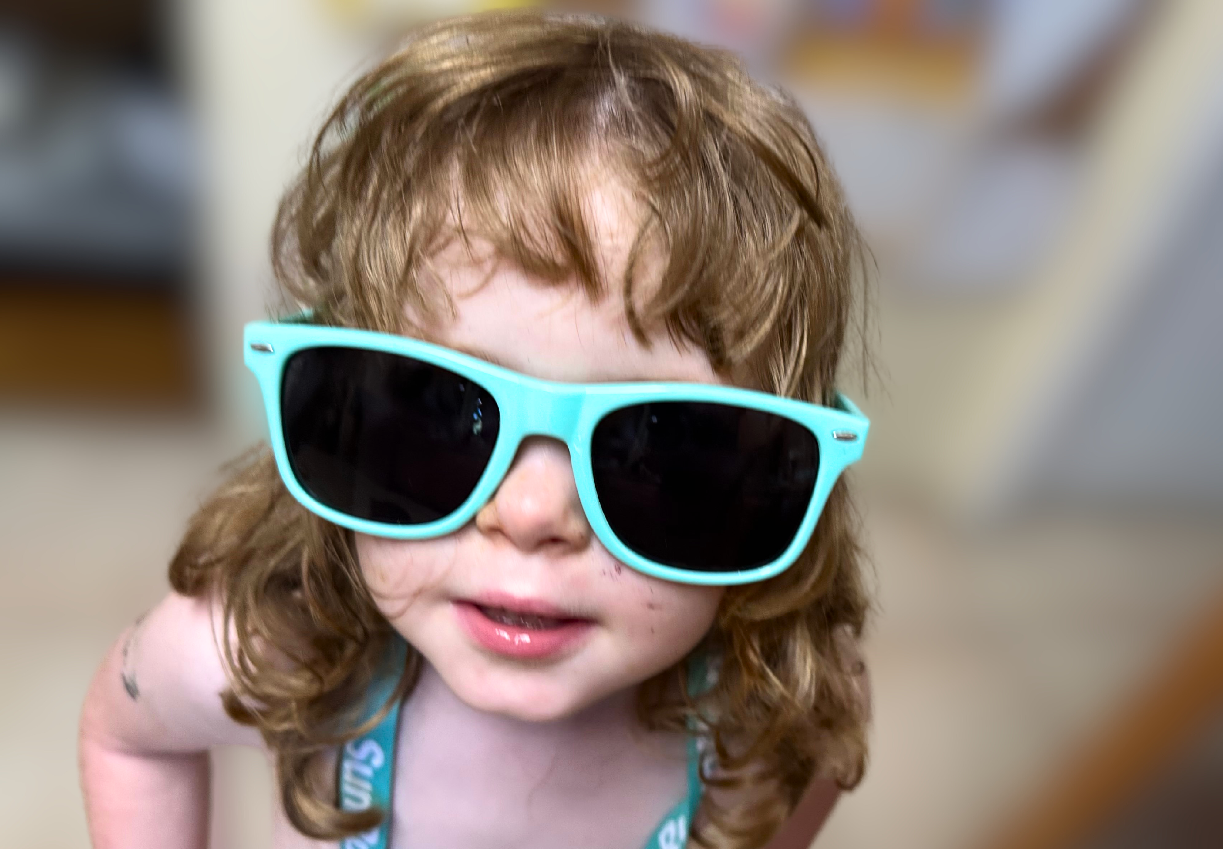 Emily wearing SunRunner branded sunglasses and lanyard