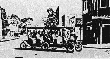 A grainy black and white photo of the first commercially operated bus in Pinellas County. It was made by welding together two Ford Model T.