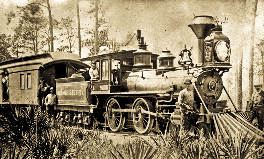 An old photograph of the Orange Belt Ry. train in Pinellas County. President and General Manager Peter Demens is standing on the right, near the front of the train.