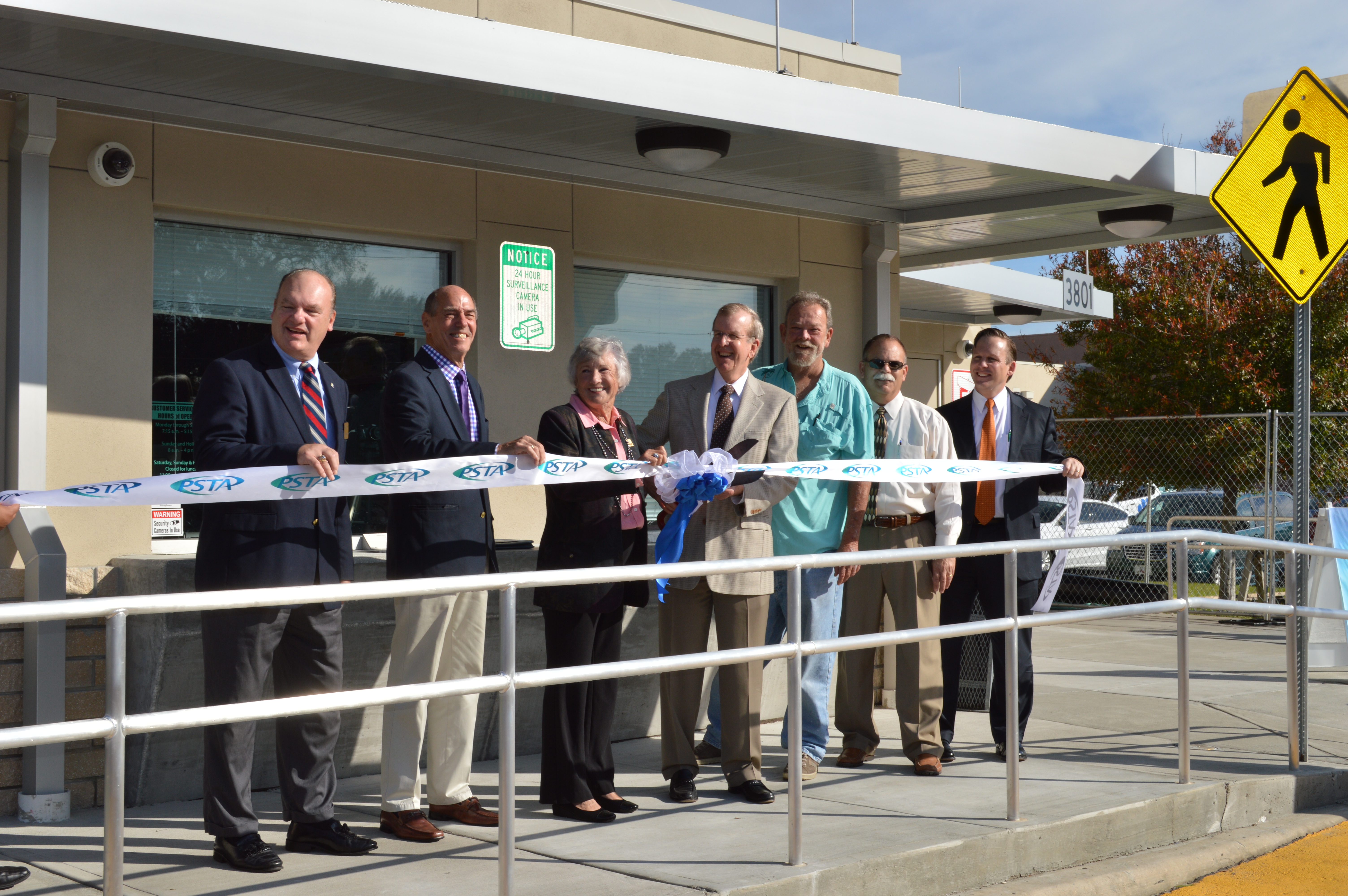 A photo of board members and PSTA leaders cutting a ribbon for the grand opening of the Pinellas Park Transit Station in 2015.