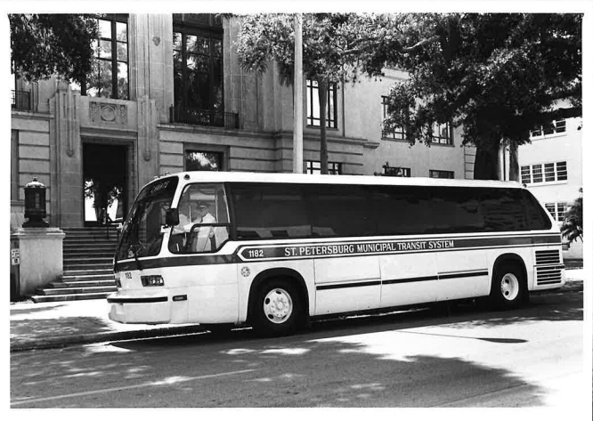 A black and white photo of an SPMTS bus in front of St. Petersburg City Hall.