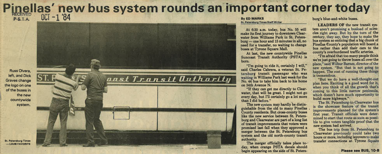 A newspaper clipping from October 1st 1984 titled "Pinellas' new bus system rounds an important corner today" and shows two men putting a Pinellas Suncoast Transit Authority decal to cover the St. Petersburg Municipal Transit System decal