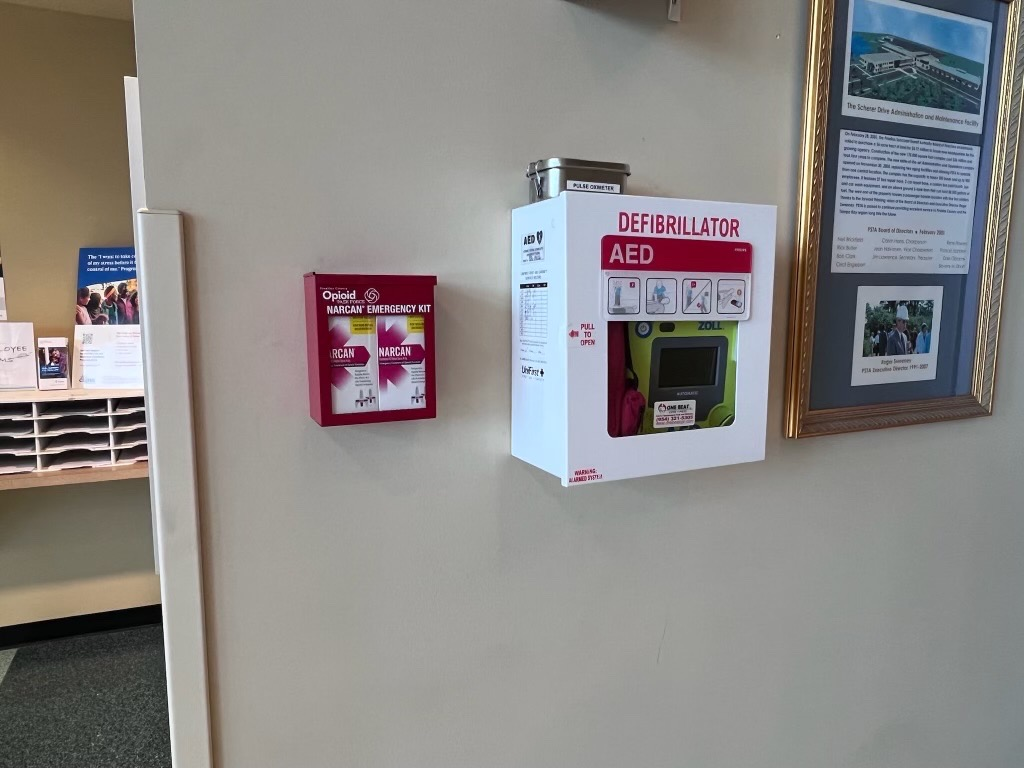 A photo of a Narcan Emergency Kit at PSTA Headquarters, installed next to the existing first aid kit and defibrillator.