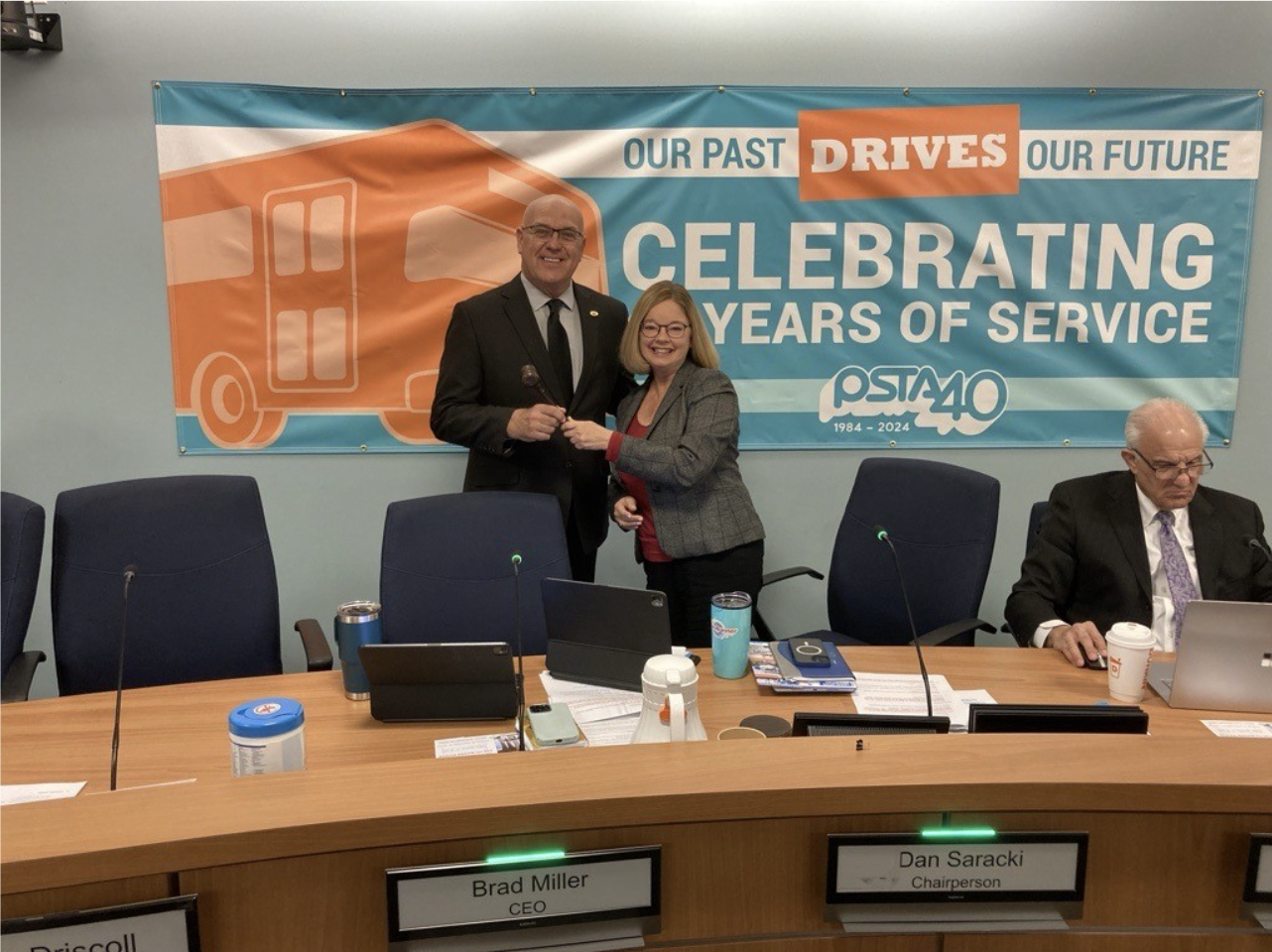 a photo of Councilmember Gina Driscoll and Mayor of Oldsmar Dan Saracki as Gina hands Dan the gavel to represent her passing the position of chairperson to Dan.