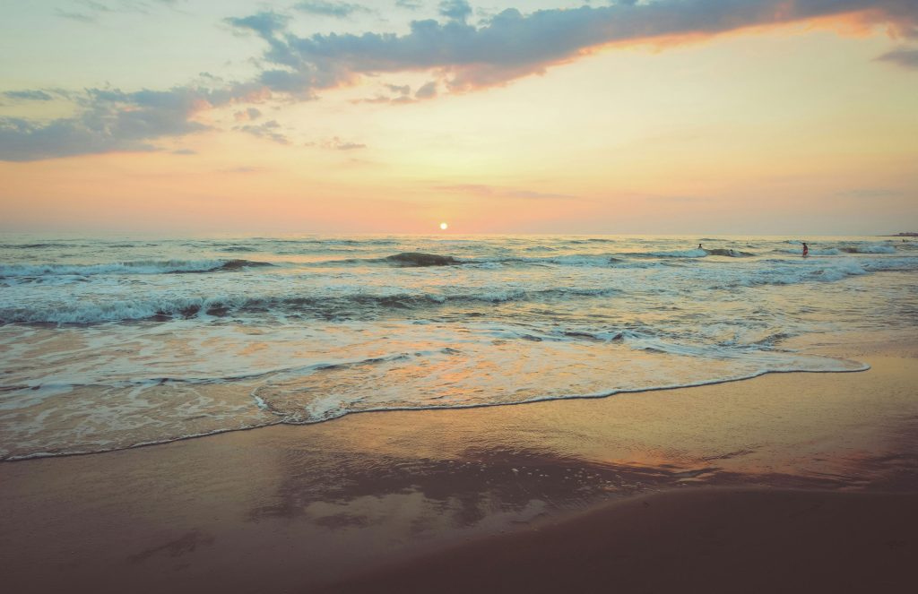 A photo of the beach at sunset with waves coming in