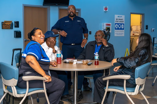 Chief Operating Officer James Bradford socializes with four bus operators in the driver's lounge.