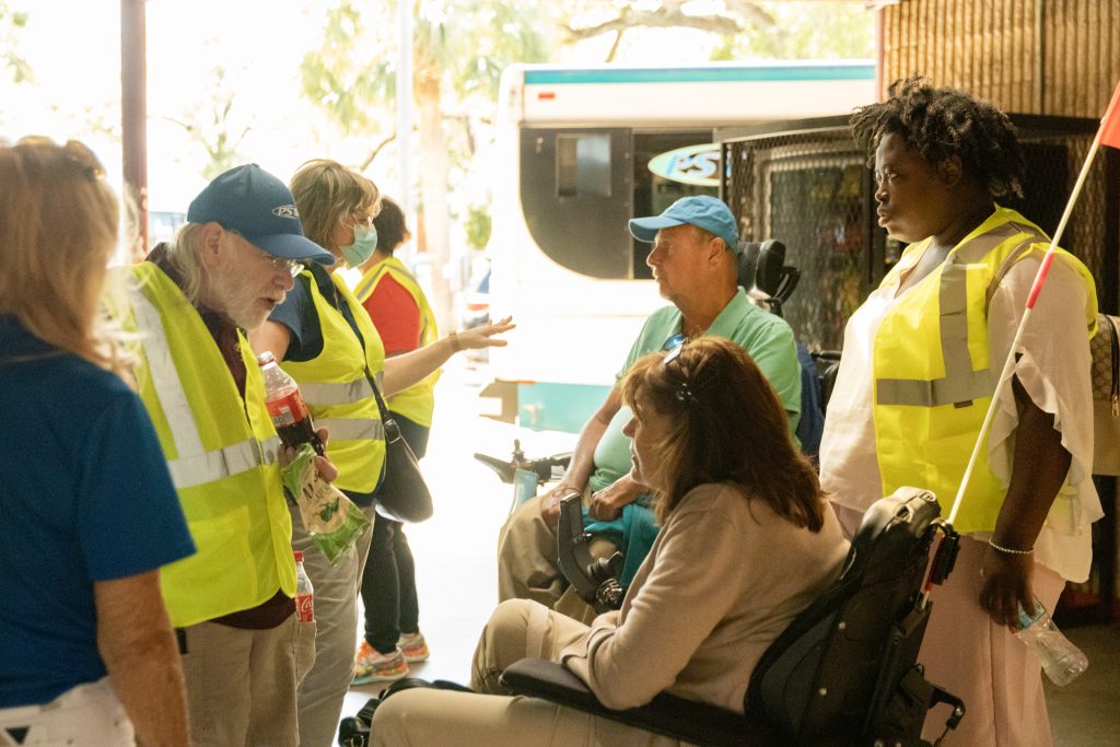 A photo of Gloria speaking with PSTA staff, along with other TRAC members touring Park Street Terminal.