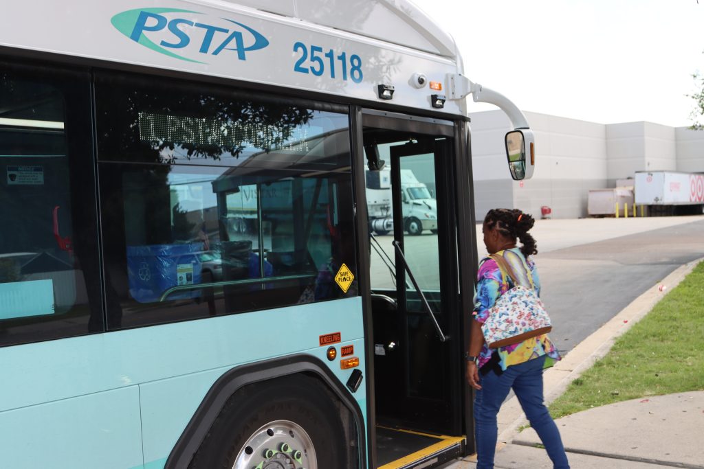 A rider walks towards the door of a Route 11 PSTA bus.